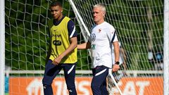 France striker Kylian Mbappe (L) and coach Didier Deschamps (R) prepare for Tuesday's Euro 2020 clash with Germany