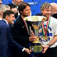 Inter Milan coach Antonio Conte (L) and team technical director Gabriele Oriali (R) hold the 'Scudetto' trophy.