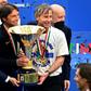 Inter Milan coach Antonio Conte (L) and team technical director Gabriele Oriali (R) hold the 'Scudetto' trophy.