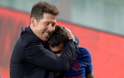 Atletico Madrid coach Diego Simeone hugs Angel Correa at the end of the game