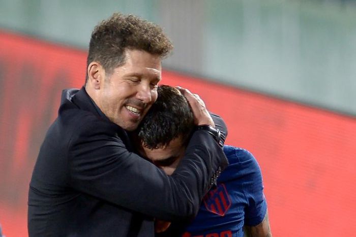 Atletico Madrid coach Diego Simeone hugs Angel Correa at the end of the game