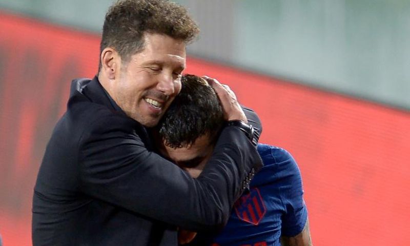 Atletico Madrid coach Diego Simeone hugs Angel Correa at the end of the game