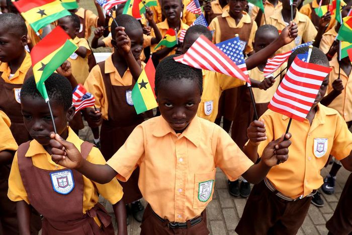 School children were on hand to welcome the American first lady, waving tiny Ghanaian and American flags.