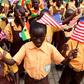 School children were on hand to welcome the American first lady, waving tiny Ghanaian and American flags.