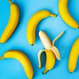 Ripe bananas on blue background