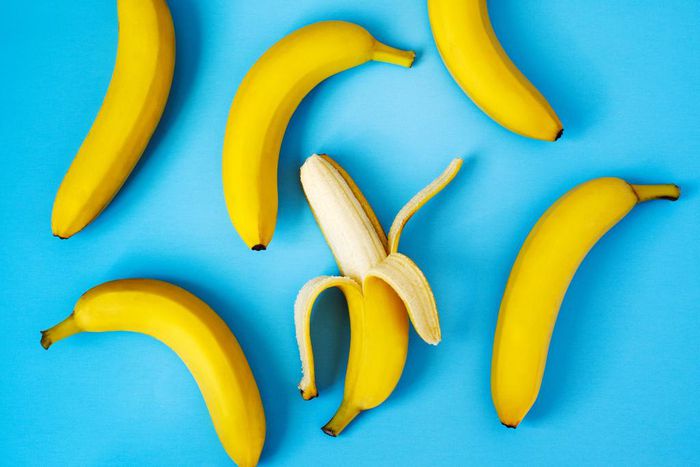 Ripe bananas on blue background