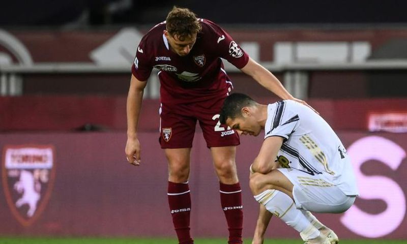 Torino defender Mergim Vojvoda (C) comforts Juventus' Cristiano Ronaldo after a 2-2 stalemate.
