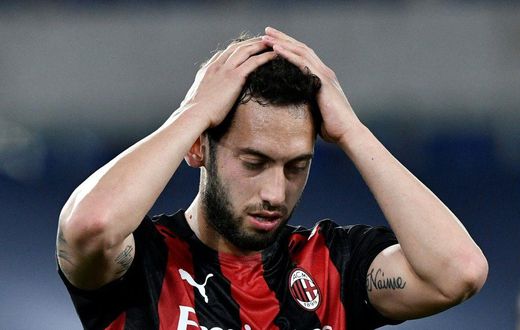 AC Milan's Turkish midfielder Hakan Calhanoglu reacts during the Italian Serie A football match Lazio vs Ac Milan at Olympic stadium in Rome on April 26, 2021.