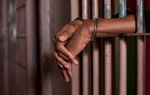 Handcuffed man in prison (Illustration purpose / loopJamaica)