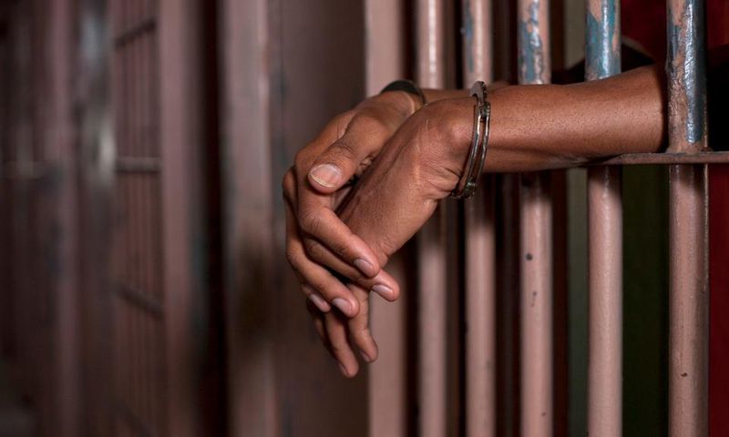 Handcuffed man in prison (Illustration purpose / loopJamaica)