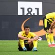 Dortmund defenders Manuel Akanji (L) and Emre Can (R) show their disappointment at Saturday's home defeat to Frankfurt which dents their Champions League hopes for next season