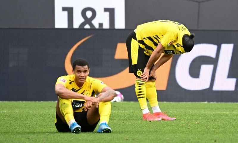 Dortmund defenders Manuel Akanji (L) and Emre Can (R) show their disappointment at Saturday's home defeat to Frankfurt which dents their Champions League hopes for next season