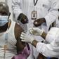 A man gets a coronavirus vaccine in the Ivory Coast with a shot secured through the COVAX scheme.