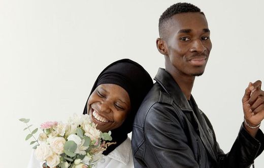 Beautiful couple smiling while standing together [Image: Darina Belonogova]