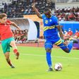 Abdelkarim Baadi (L) of Morocco attempts to block a cross by Ernest Sugira of Rwanda during  an African Nations Championship match in Douala Friday.
