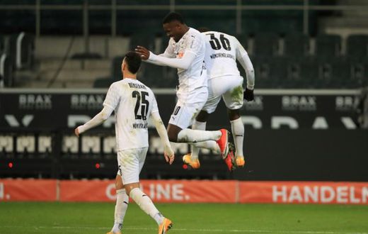Marcus Thuram (C) celebrates scoring for Borussia Moenchengladbach in Friday's 4-2 win over Dortmund