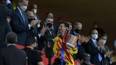 Lionel Messi collects the Spanish Copa del Rey after Barcelona's 4-0 win over Athletic Bilbao in April