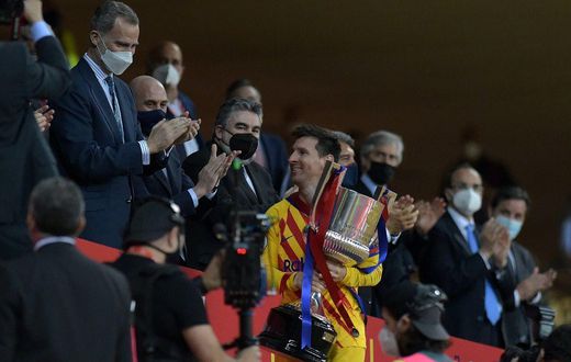 Lionel Messi collects the Spanish Copa del Rey after Barcelona's 4-0 win over Athletic Bilbao in April