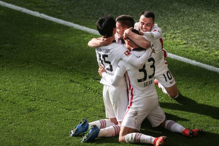 Frankfurt's Portuguese forward Andre Silva celebrates with teammates scoring a late winner against Borussia Dortmund on Saturday