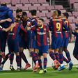 Saved at the death: Barcelona players celebrate Gerard Pique's injury time goal