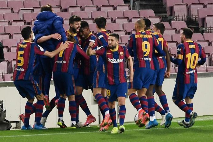 Saved at the death: Barcelona players celebrate Gerard Pique's injury time goal