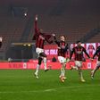 AC Milan's Italian coach Pioli (2ndL) celebrates with his players after holding onto top spot in Serie A