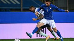 Italy midfielder Lorenzo Pellegrini (R) pulled up injured in training.