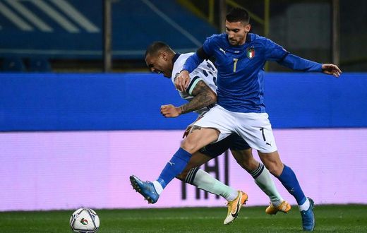 Italy midfielder Lorenzo Pellegrini (R) pulled up injured in training.