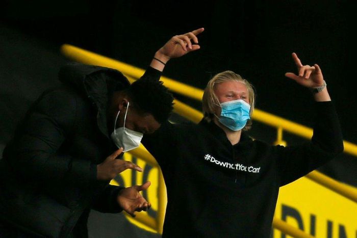 Injured Dortmund striker Erling Braut Haaland (R) celebrates his side's 3-2 win over RB Leipzig on Saturday