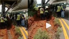 Airplane gets stuck in mud after skidding off the runway
