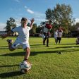 A child kicks a ball at the new football school for children with learning difficulties set up by Argentine team Newell's Old Boys
