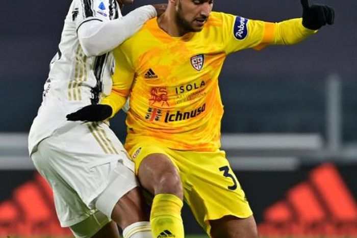 Algerian midfielder Adam Ounas (R) holds off Juventus defender Danilo when playing for Cagliari last November in Turin.