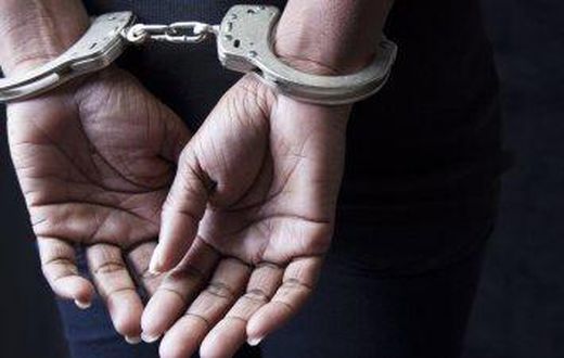 A woman .in handcuffs