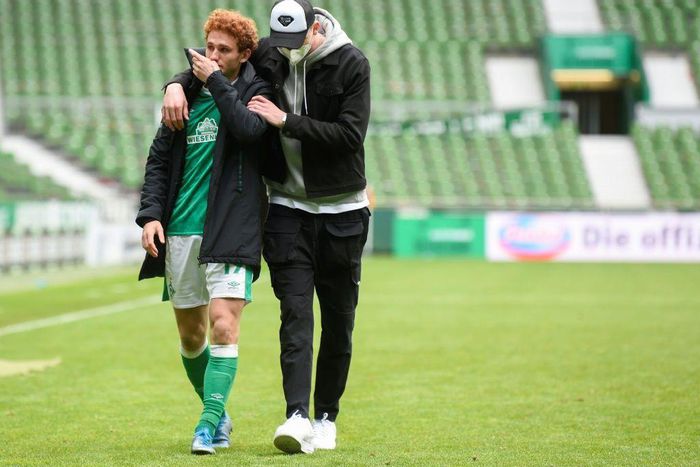 US forward Joshua Sargent (L) is comforted after Werder Bremen were relegated from the Bundesliga on Saturday