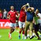 A Madagascar player pours water over coach Nicolas Dupuis (C) after  a shock victory over Nigeria at the 2019 Africa Cup of Nations in Egypt.