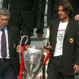 Shared glory: Carlo Ancelotti and  his captain Paolo Maldini bring the Champions League trophy back to Milan in 2003