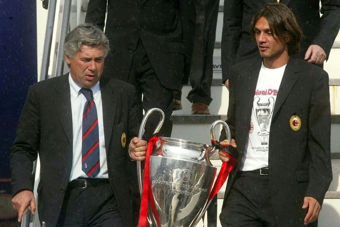 Shared glory: Carlo Ancelotti and  his captain Paolo Maldini bring the Champions League trophy back to Milan in 2003