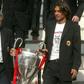 Shared glory: Carlo Ancelotti and  his captain Paolo Maldini bring the Champions League trophy back to Milan in 2003