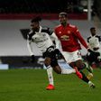 Andre-Frank Zambo Anguissa (L) in action against Paul Pogba and Manchester United earlier this season