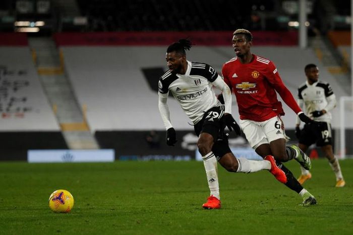 Andre-Frank Zambo Anguissa (L) in action against Paul Pogba and Manchester United earlier this season