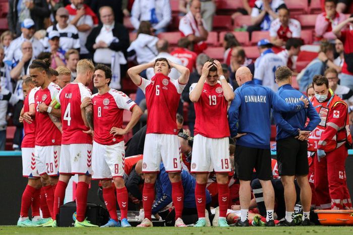 Denmark's distraught players form a ring as paramedics attend to Christian Eriksen after his collapse
