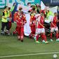 Denmark's players gather as medics treat midfielder Christian Eriksen during the Euro 2020 match against Finland