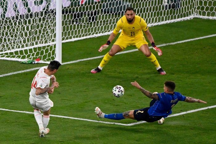 Swiss midfielder Steven Zuber (L) had a shot saved by Gianluigi Donnarumma (C)