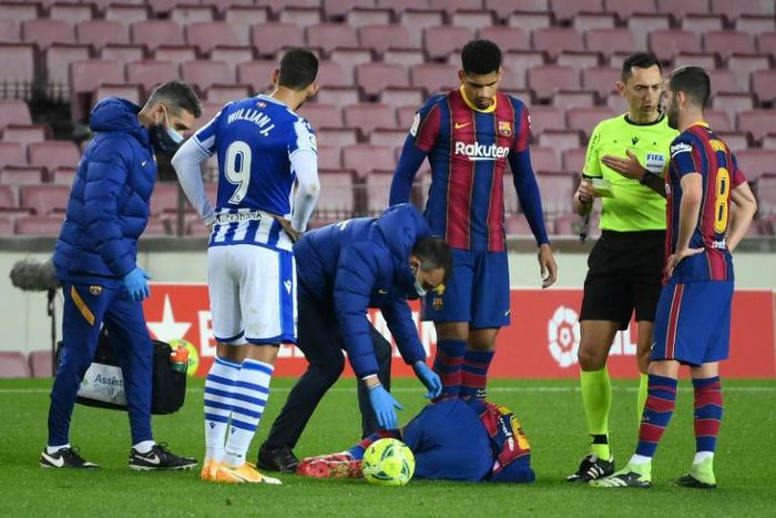 Down but not out: Lionel Messi lays on the ground after a foul