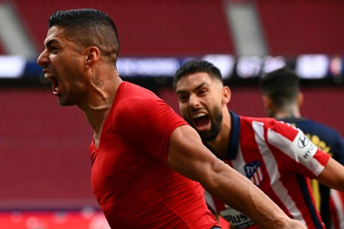 Late joy: Luis Suarez celebrates the late winner that preserved Atletico Madrid's Liga lead