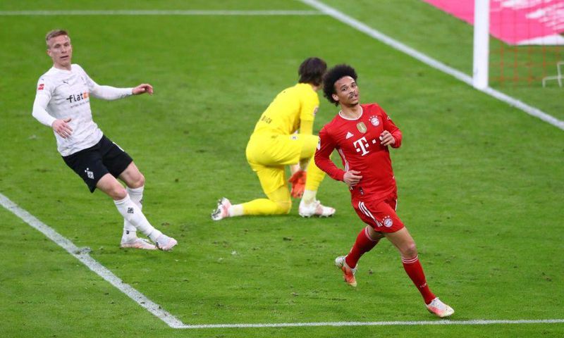 Leroy Sane (R) celebrates scoring Bayern Munich's final goal in a 6-0 thrashing of Moenchengladbach
