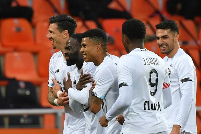 Jonathan Ikone (2ndL) celebrates with his teammates after scoring Lille's third goal in their win at Lorient on Sunday