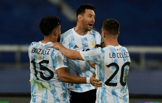 Argentina's Lionel Messi (center) celebrates his goal against Chile at the 2021 Copa America with teammates Nicolas Gonzalez (left) and Giovani Lo Celso
