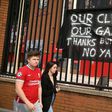 Supporters protest against Liverpool's US owner John W. Henry and the Fenway Sports Group