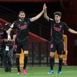 Real Madrid's Karim Benzema (left) celebrates scoring a goal with 19-year-old defender Miguel Gutierrez against Granada on Thursday.